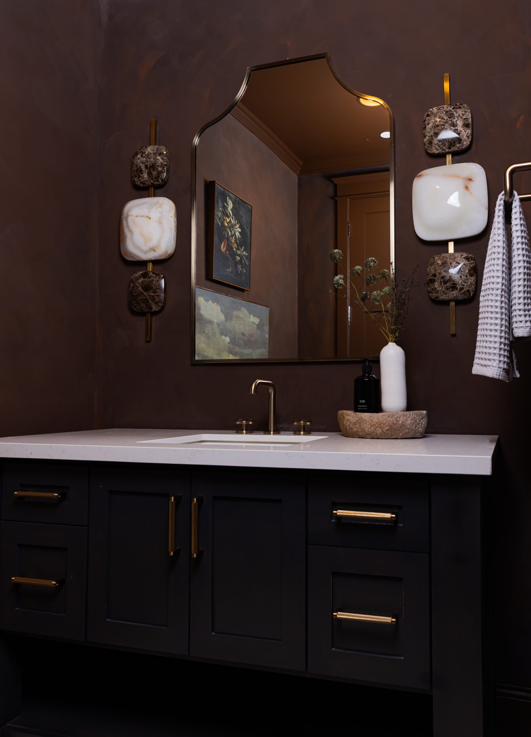 Dark brown vanity bathroom with warm lighting by Smyth House Interior Design