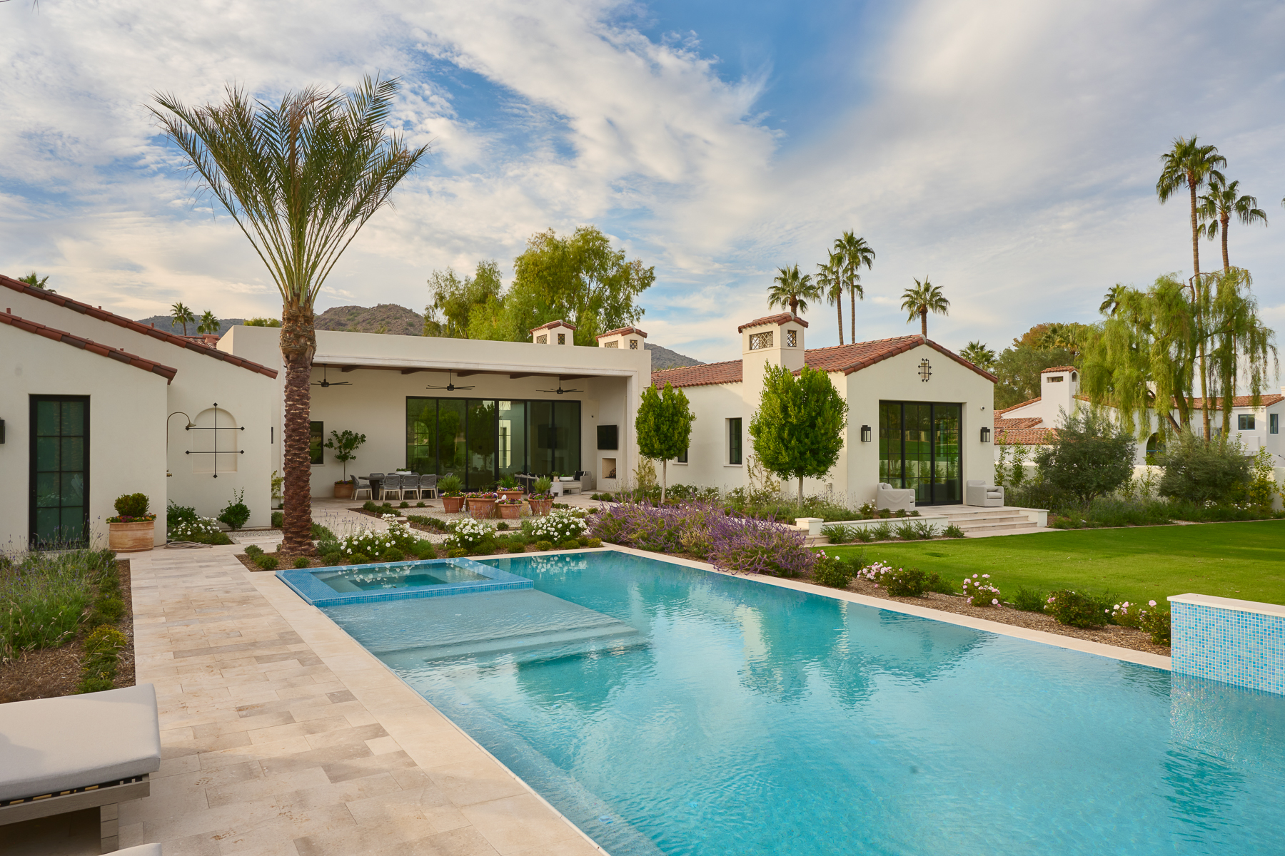 Luxury Arizona backyard with pool, desert landscaping, and indoor-outdoor living designed by Smyth House Interior Design.