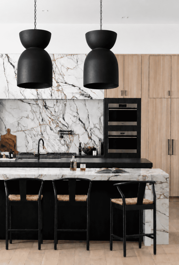 Copal pendant lighting from the Smyth House x Palo Santo collaboration featured above a luxury kitchen with dramatic marble surfaces, warm wood cabinetry, and sculptural black fixtures in a modern Arizona home.